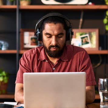 man with headphones working on his computer
