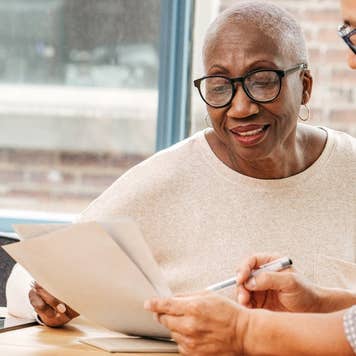 What is a probable sale - african american woman with gray hair going over paperwork with hispanic man