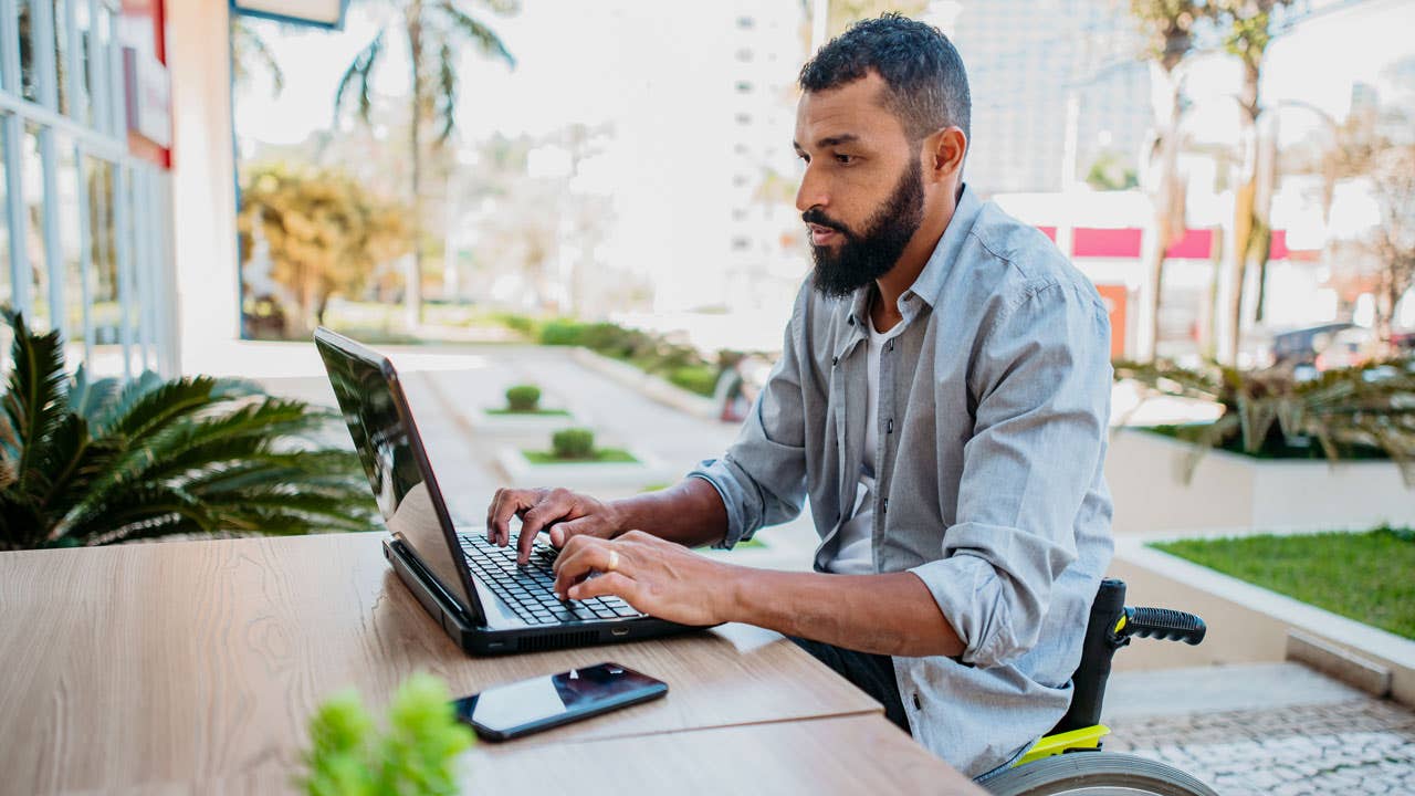 man working on his laptop outdoors