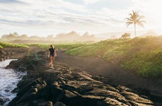 a girl walking on the coast in hawaii