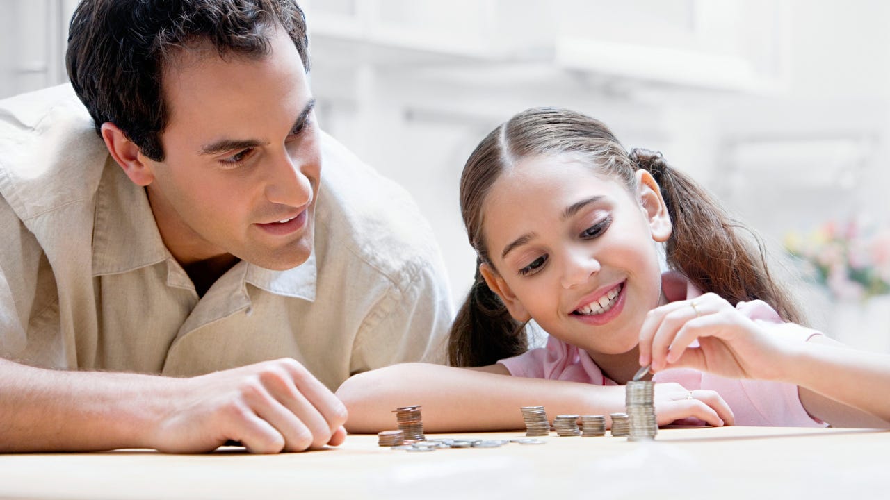 Father and daughter counting coins