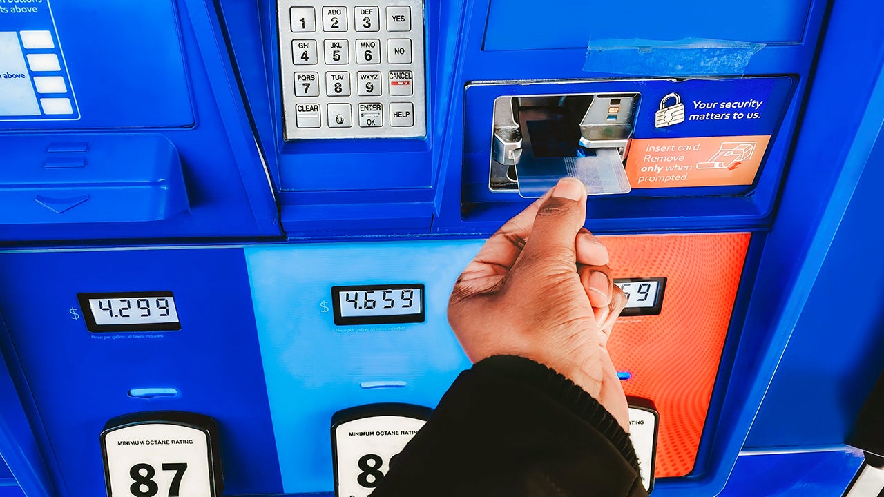 woman purchasing gas with a credit card