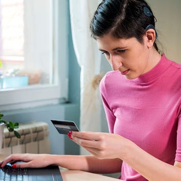 woman with cochlear implant using laptop at home