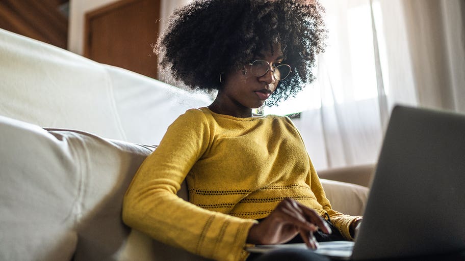 teenager using laptop at home