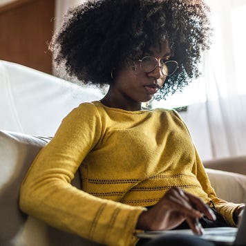 teenager using laptop at home