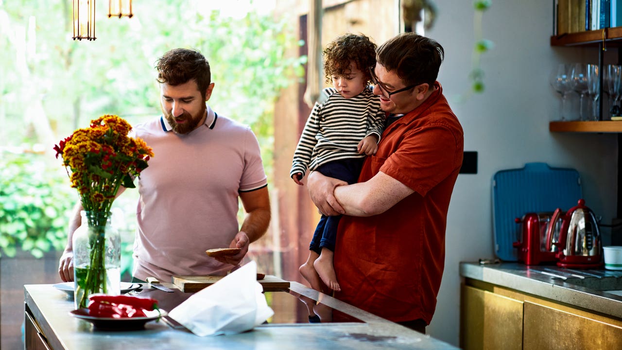 couple at home in their kitchen with their son