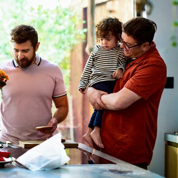 couple at home in their kitchen with their son