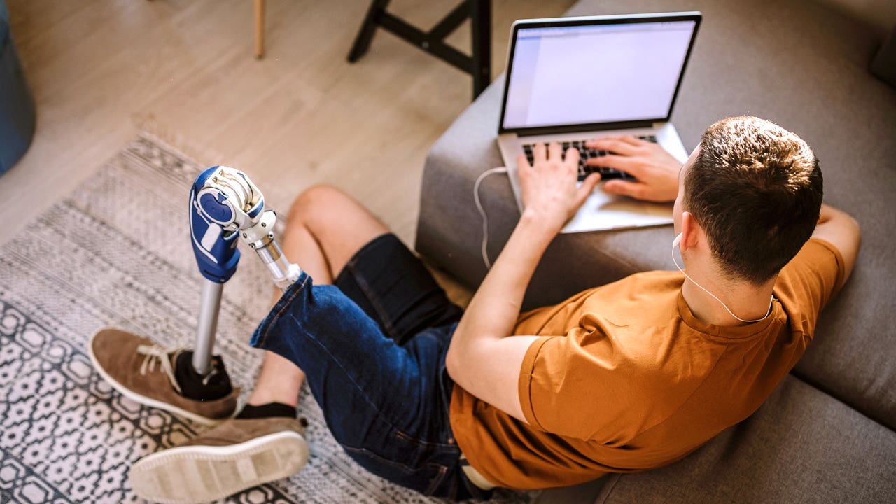 young man working on his laptop in his living room