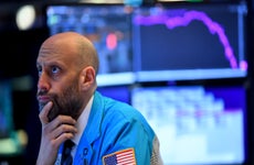 A trader thinks on the floor of the stock exchange