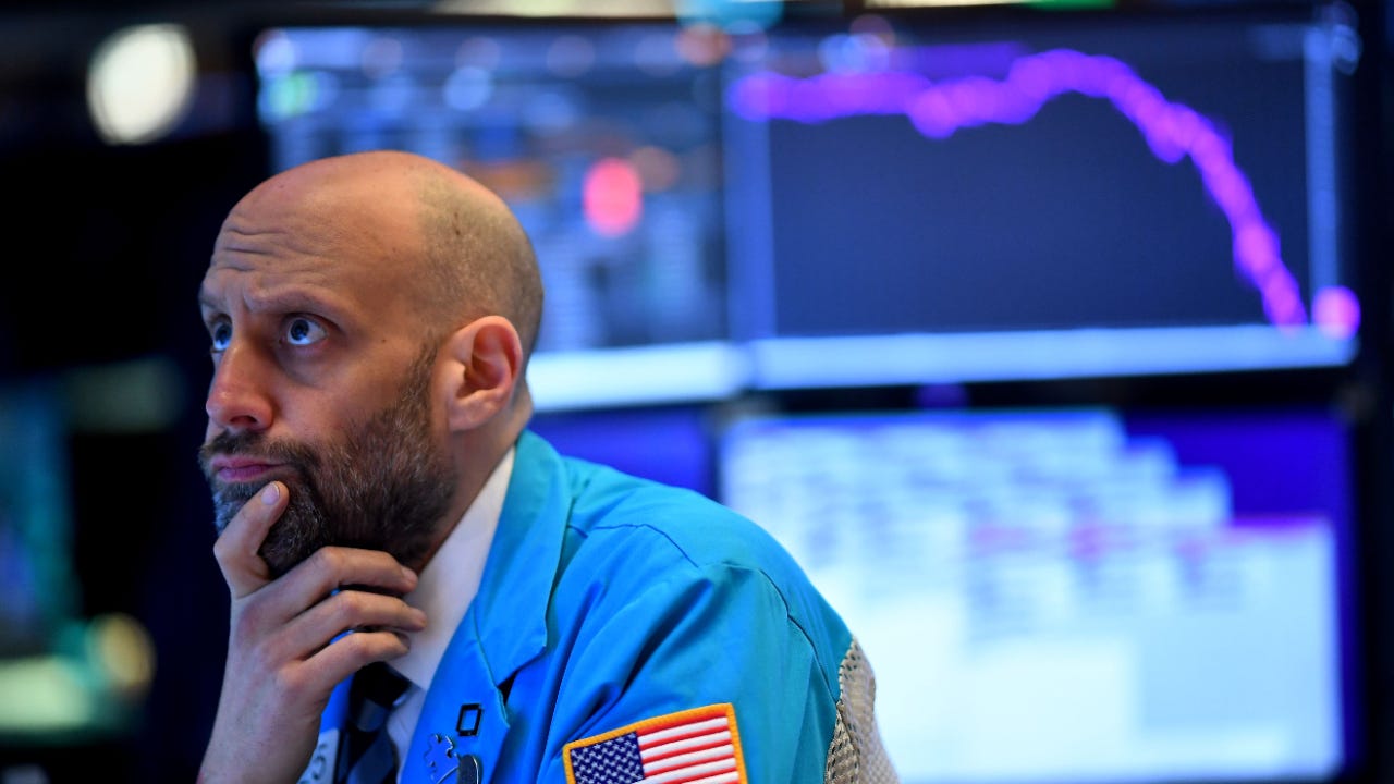 A trader thinks on the floor of the stock exchange