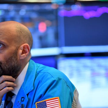 A trader thinks on the floor of the stock exchange