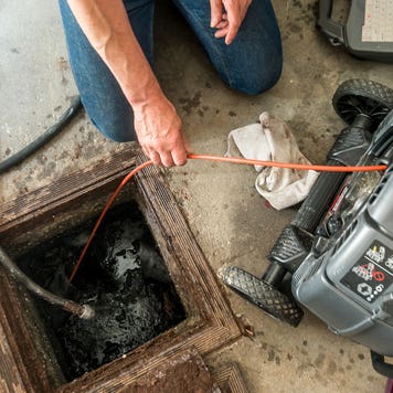 Inspecting the damage on a home sewer pipe with a remote camera
