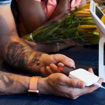 man paying with a credit card at a store