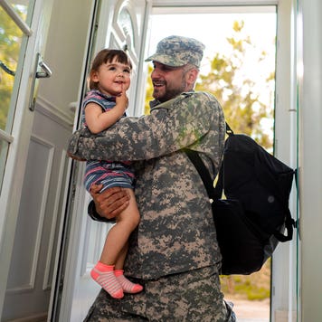 military father hugging his daughter when arriving home