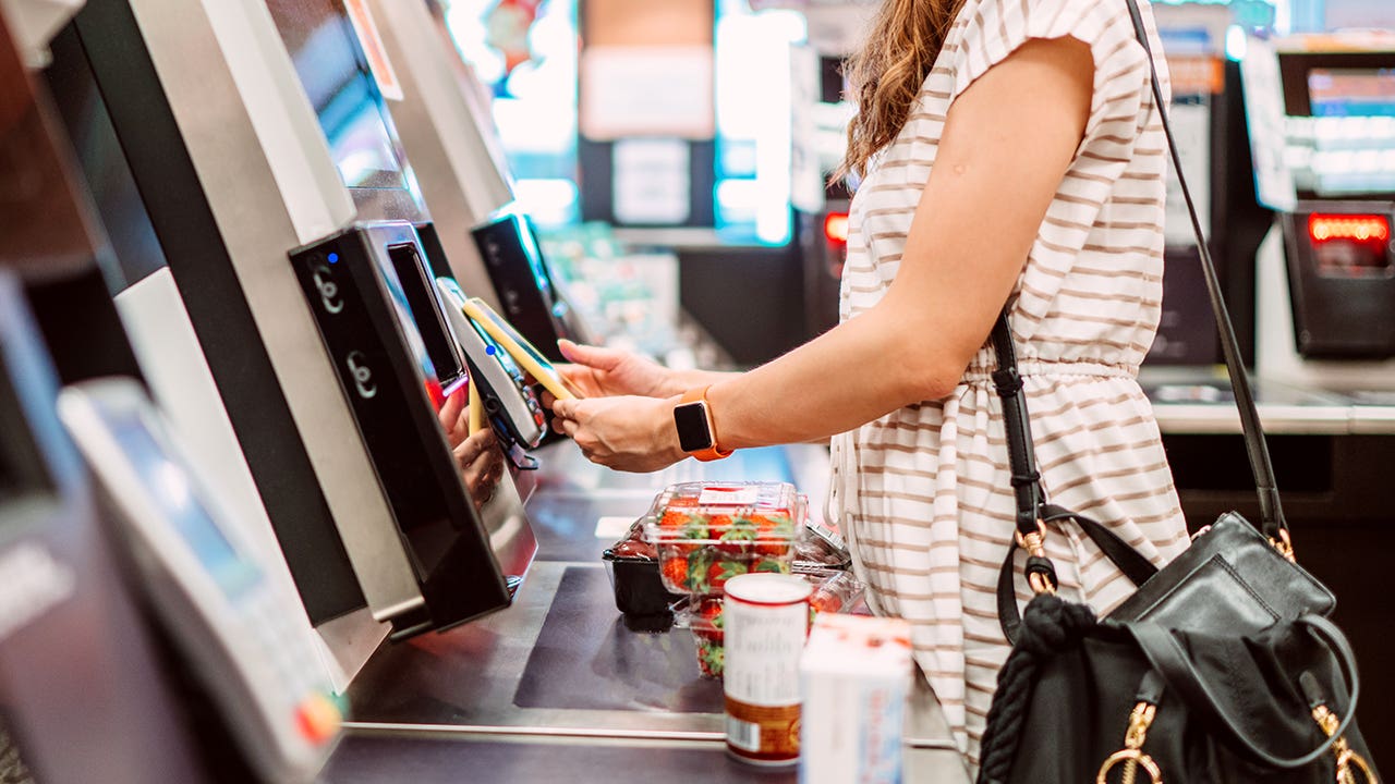 woman at grocery slef checkout