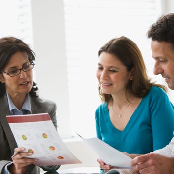 A couple speaks with a financial advisor