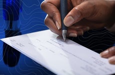 close up of person signing a check