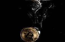 A physical Bitcoin plunges into water