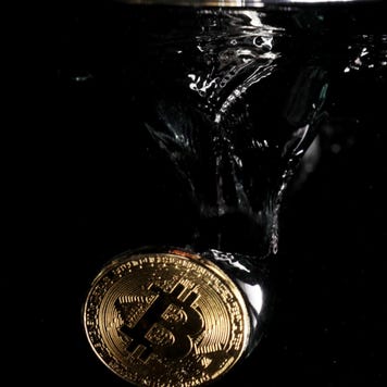 A physical Bitcoin plunges into water