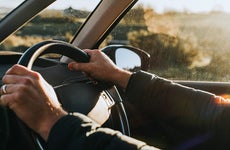 hands holding steering wheel of car