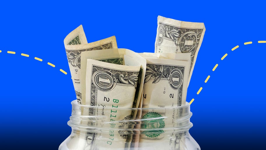 dollar bills in a glass jar