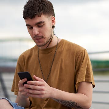 person making mobile payment outdoors