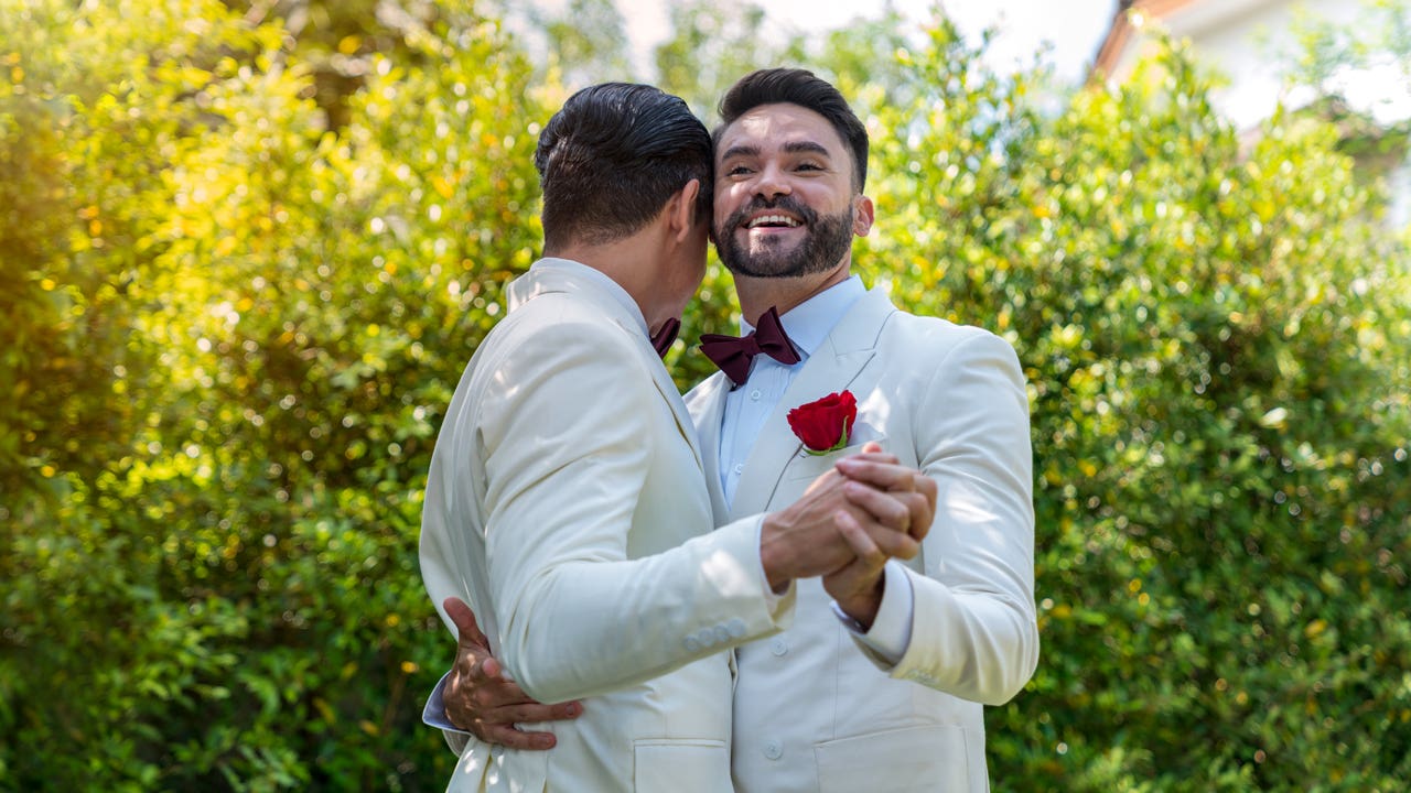 Gay couple dancing at their wedding