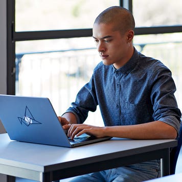 student working on his laptop