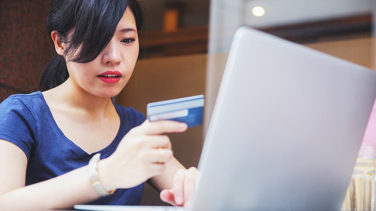 woman using a credit card to shop online