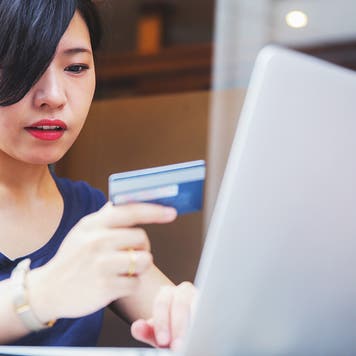 woman using a credit card to shop online