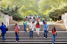 College students walk down stairs on campus