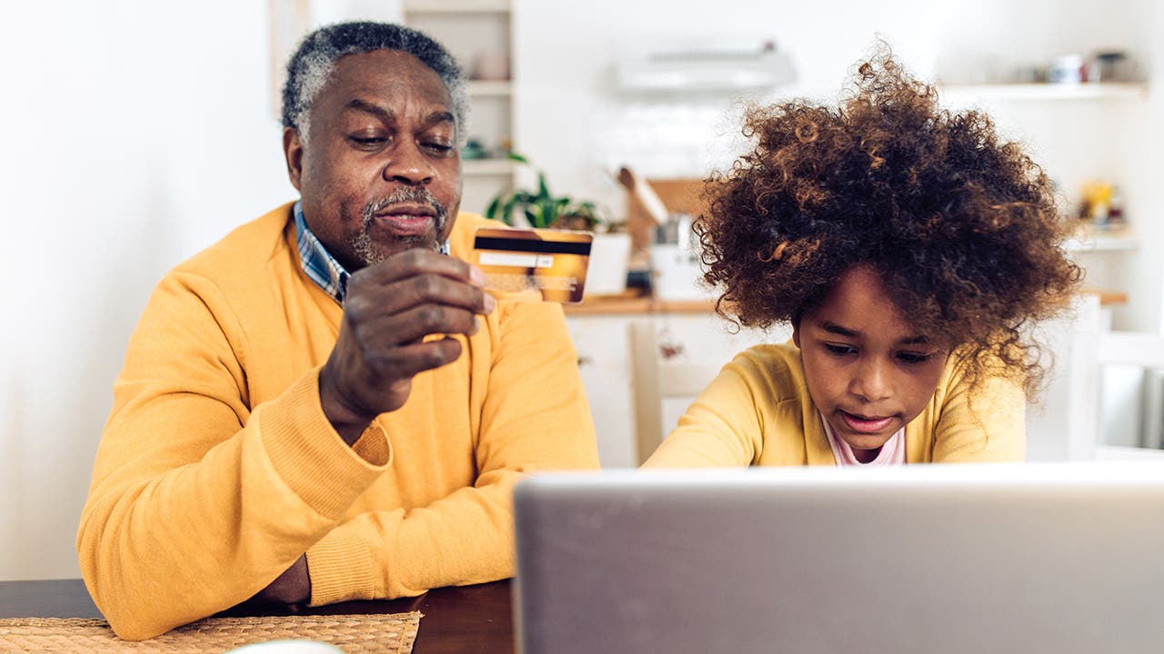 man and his child shopping online at home