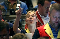 A woman trader signals to buy in the options exchange