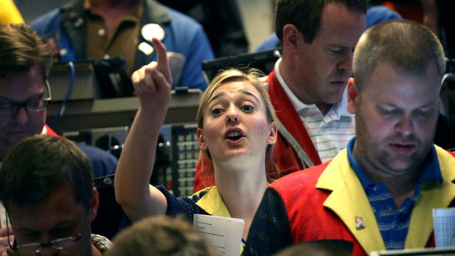 A woman trader signals to buy in the options exchange