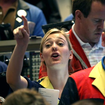 A woman trader signals to buy in the options exchange