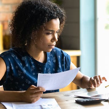 woman working on financial paperwork