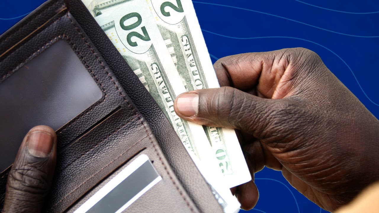 man reaching into wallet and pulling out cash