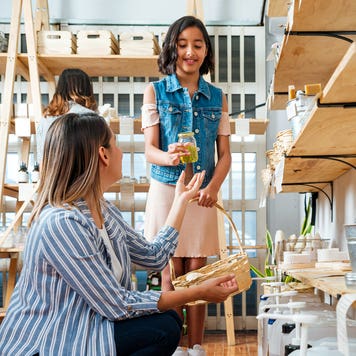 mother and young daughter shopping together in a store