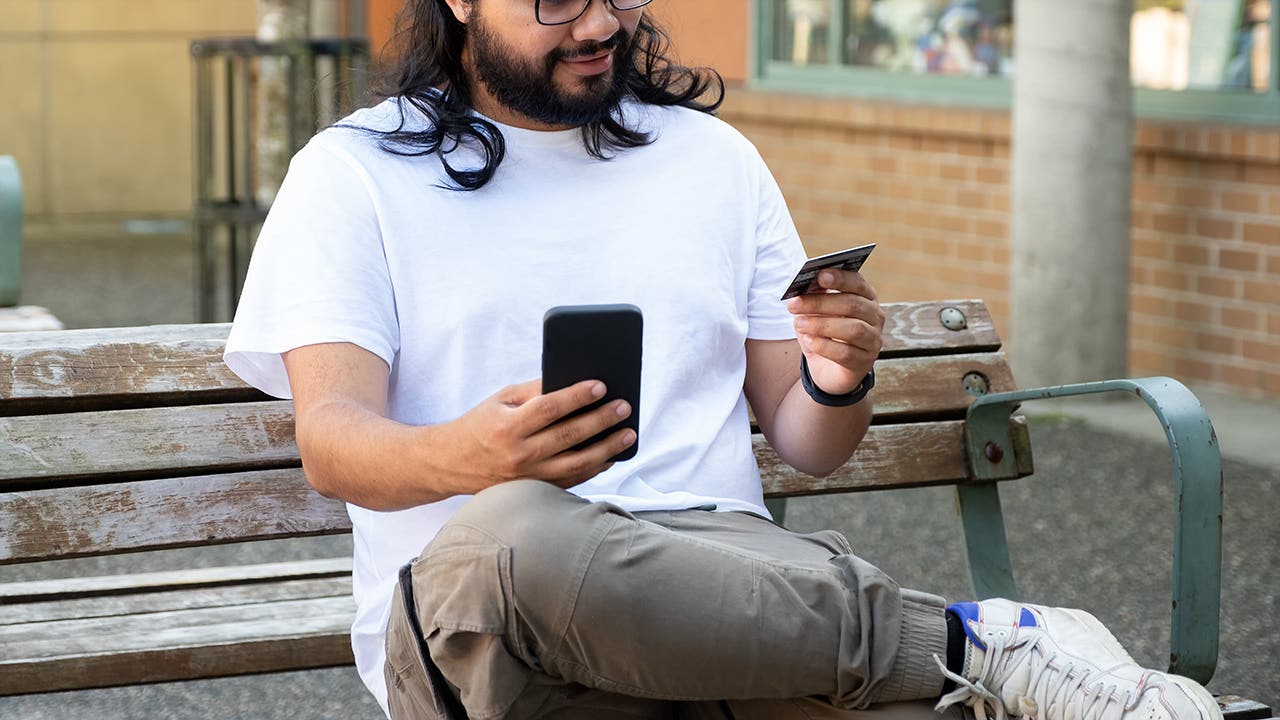 young man shopping on his phone