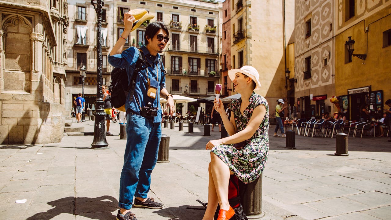 couple relaxing in a city square in Barcelona, Spain