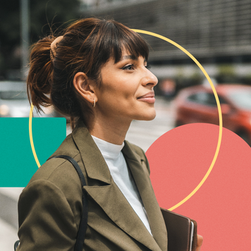 young woman smiling on city sidewalk