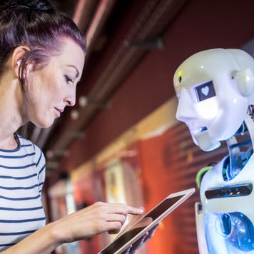 A woman interacts with a robot