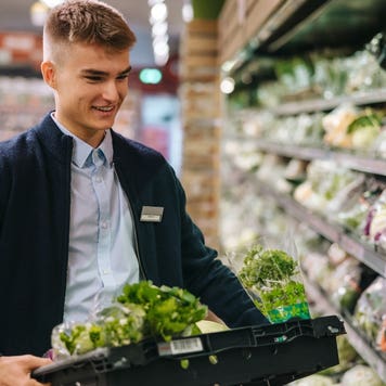 Grocery store employee restocking shelves
