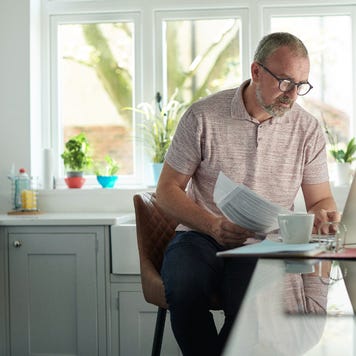 Man works on laptop in kitchen