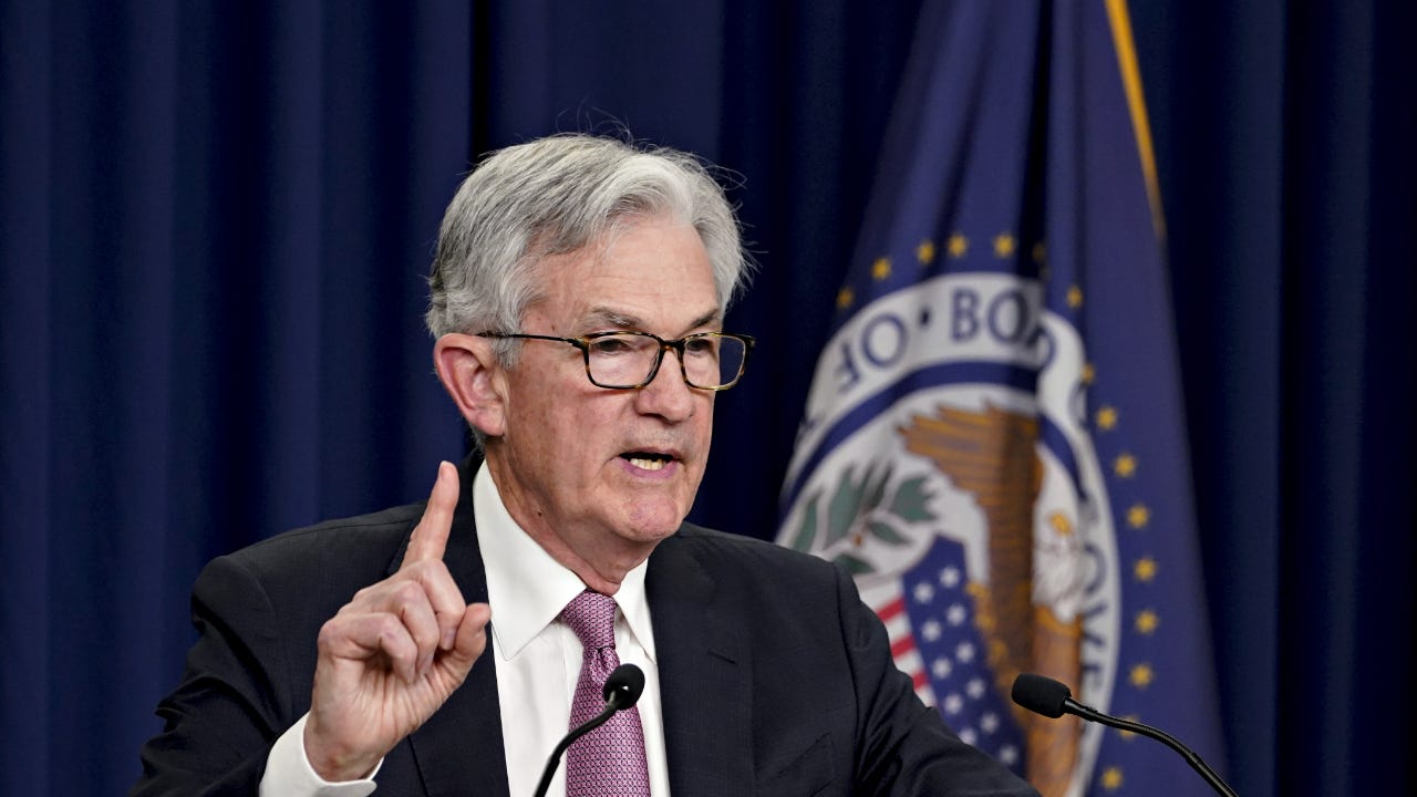 Fed Chair Jerome Powell points up during a press conference