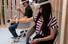 Two people use a VR headset