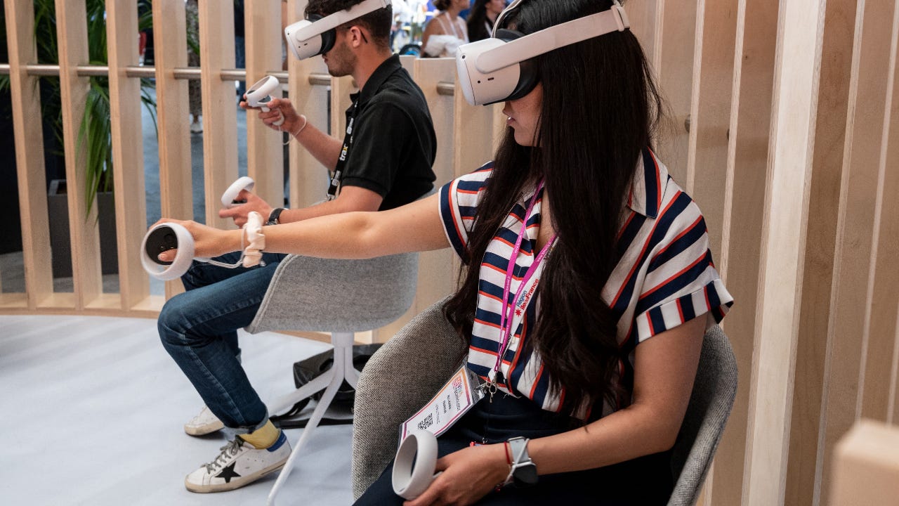 Two people use a VR headset