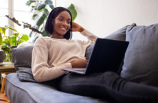 Woman using laptop on couch