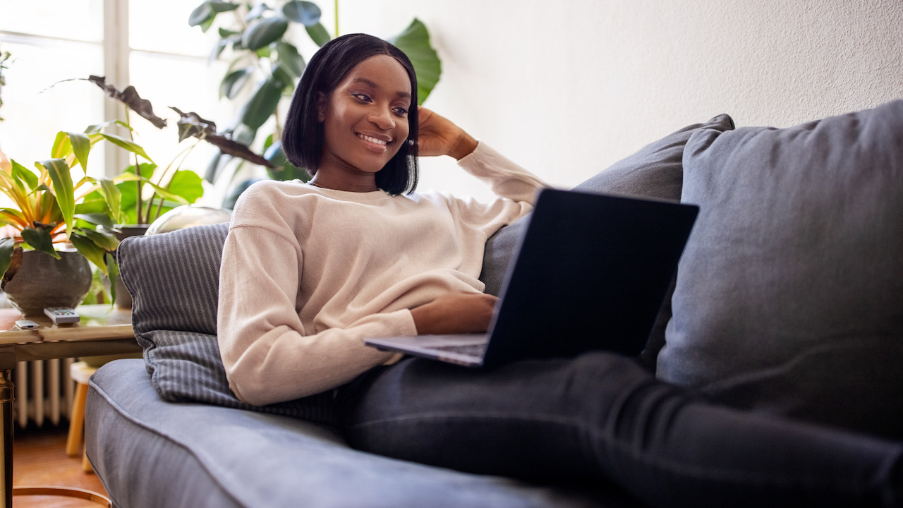 Woman using laptop on couch