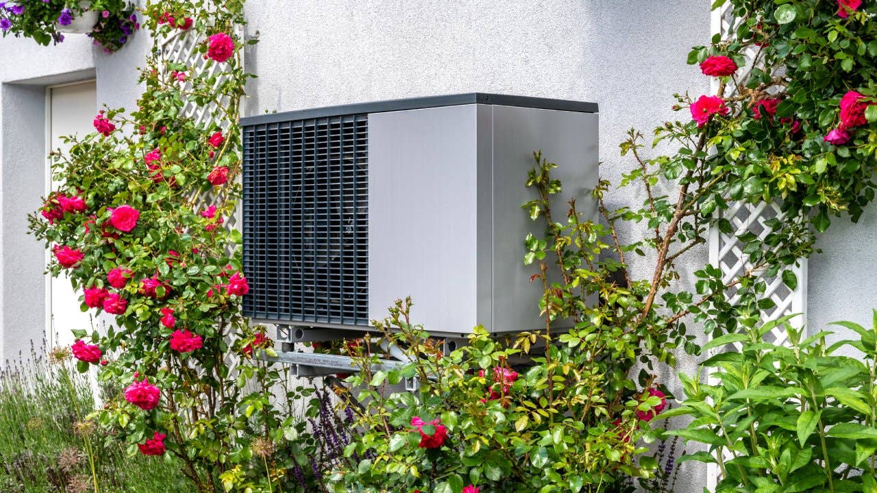 A heat pump located on the side of a home